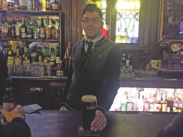 Fourth-generation Peter McManus Cafe owner Justin McManus serves up a well-poured Guinness. File photo by Dennis Lynch.