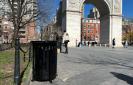 Black waste bin with the Washington Square Park Arch in the background