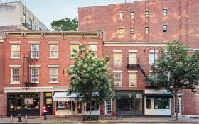 Four historic commercial storefronts on the corner of Bleecker and Christopher Streets in the West Village.