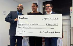 Image of greenwich house staff receiving large check from spectrum